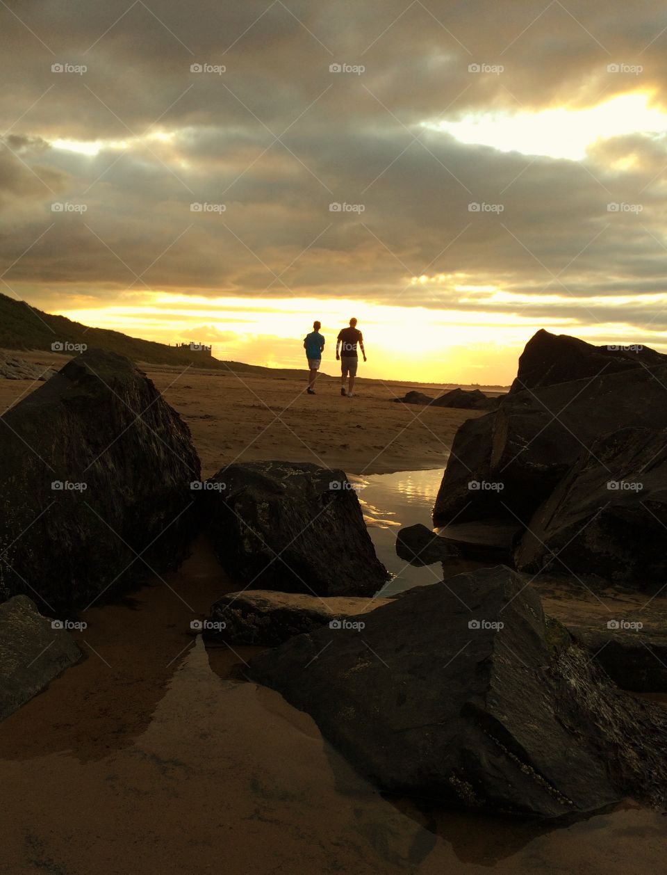 Going Home. Walking behind my family along the beach, heading for home during a cloudy sunset .....