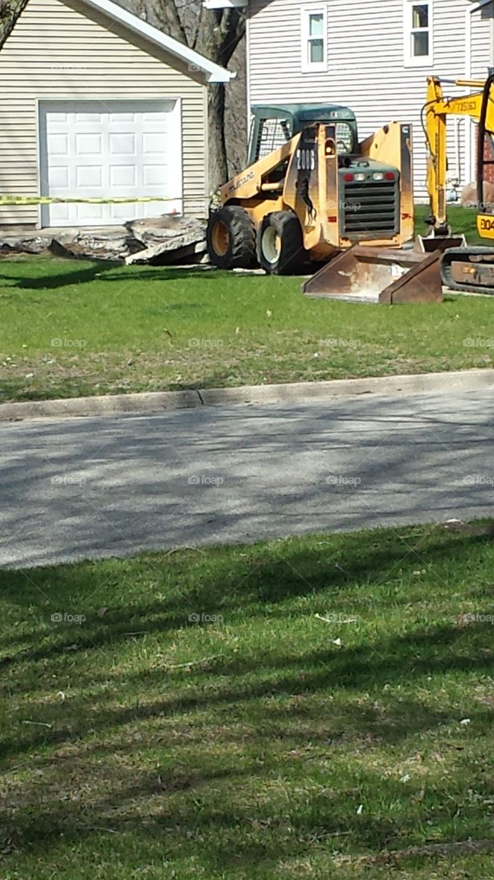 A driveway being torn up.