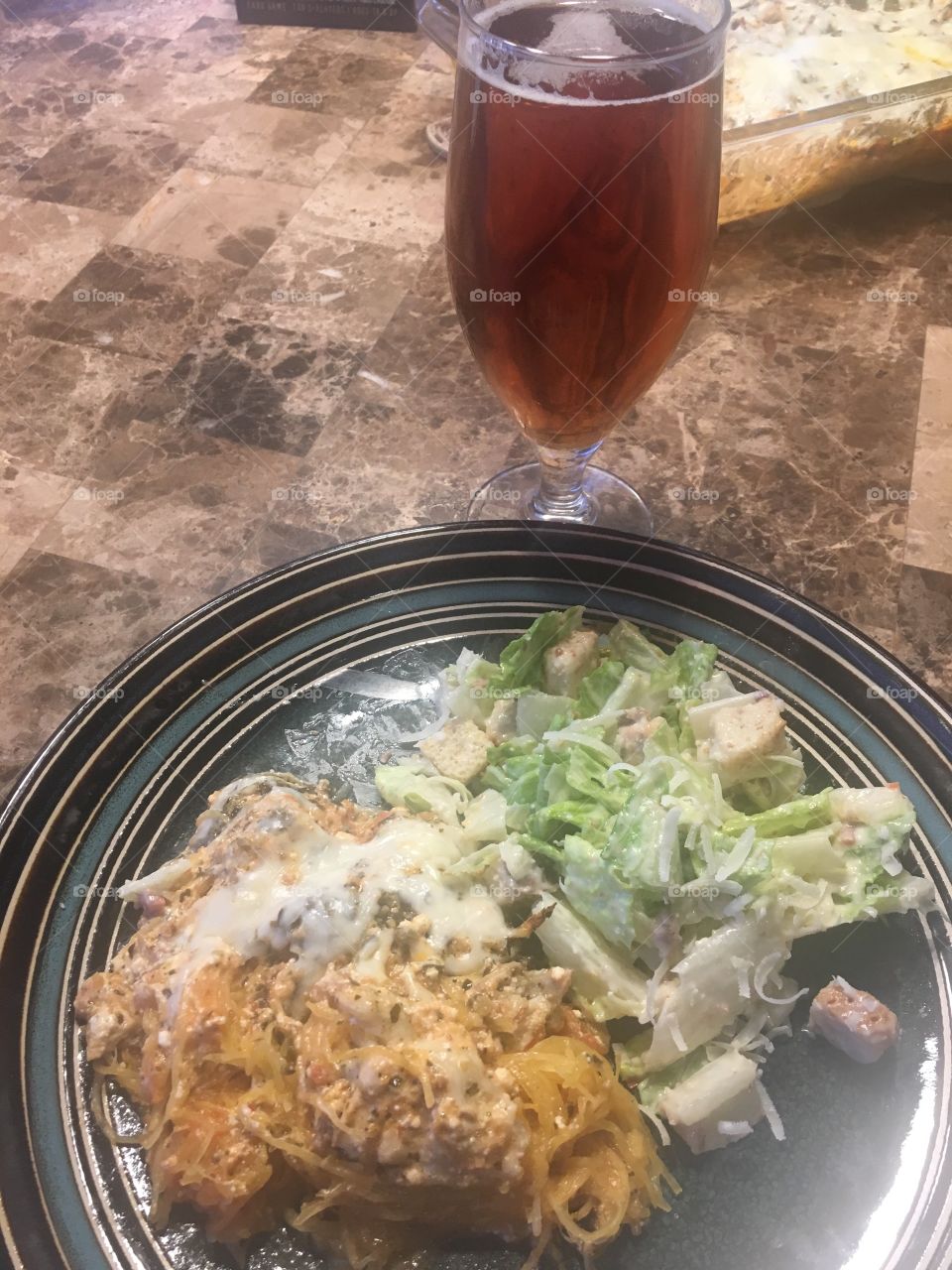 Pesto chicken spaghetti squash bake with Caesar salad and beer 