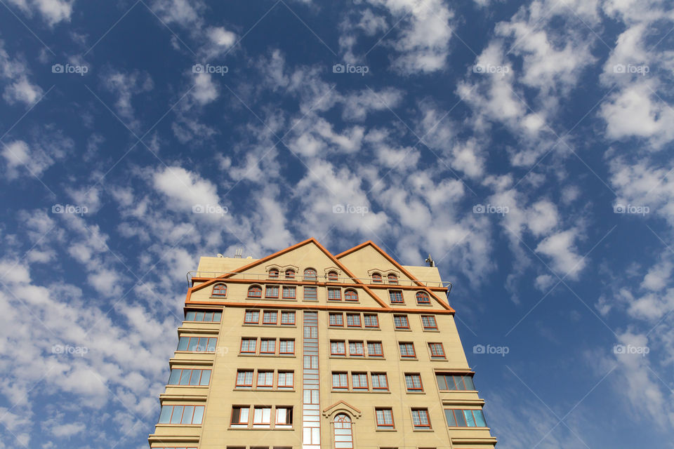 Residential building against blue cloudy sky