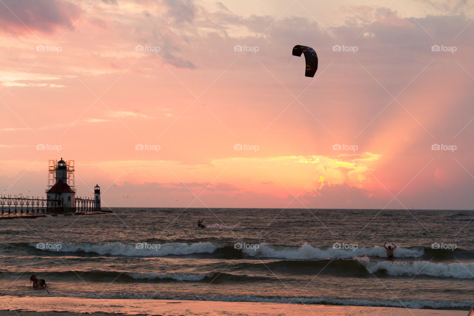 kite boarding by the pier