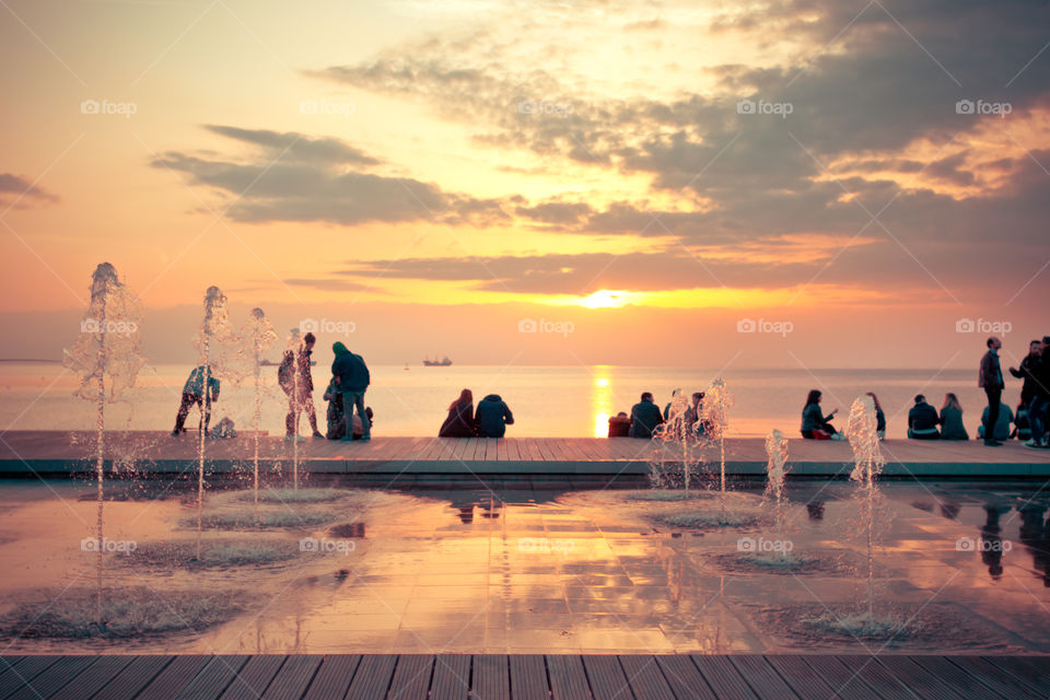 People At The Dock Enjoying The Sunset
