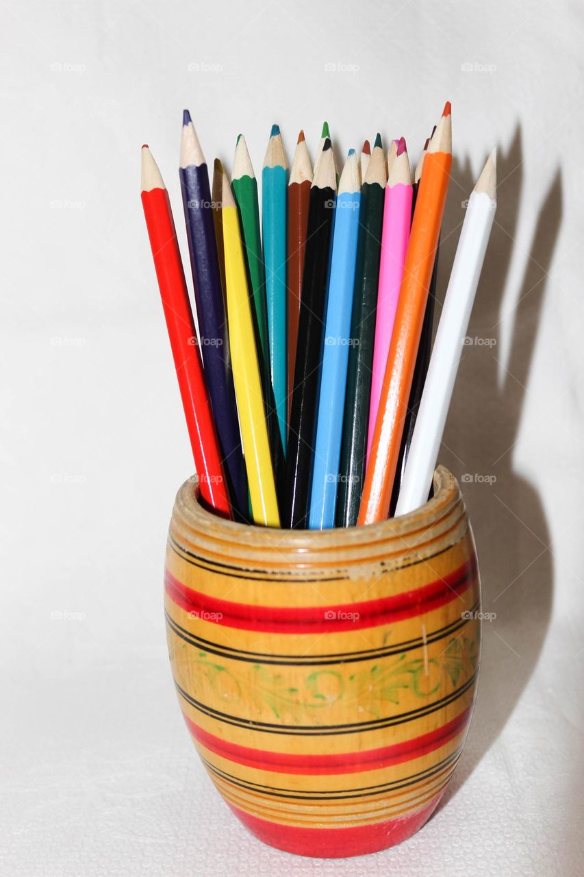 Colored pencils in a wooden glass