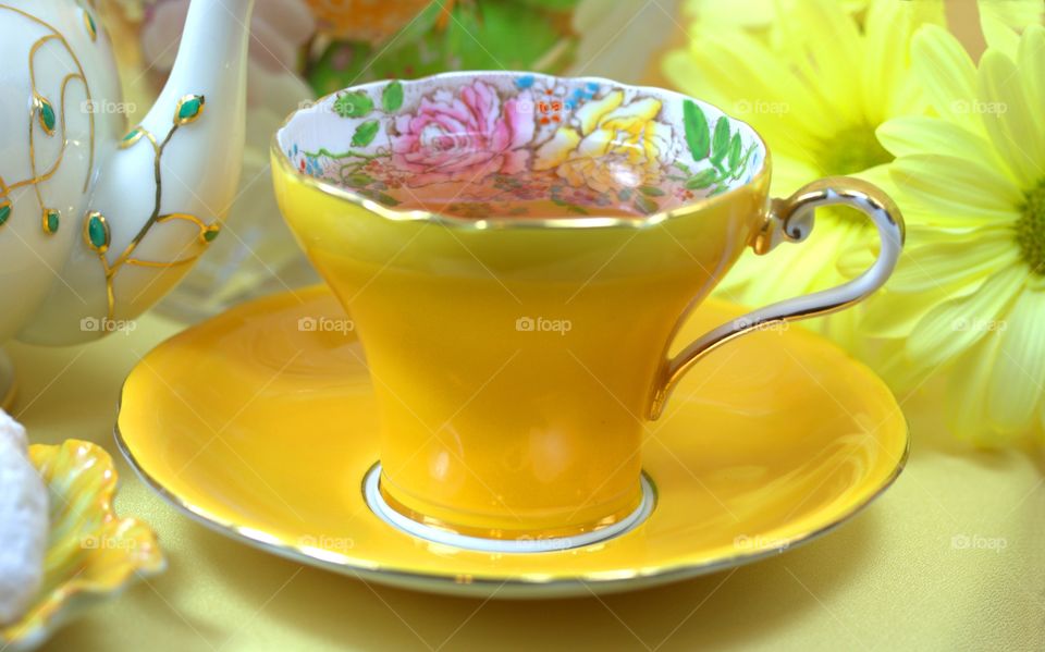yellow teacup with flowera