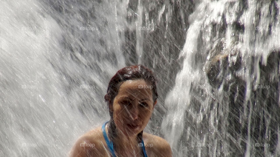 Tourist bathing in a waterfall 