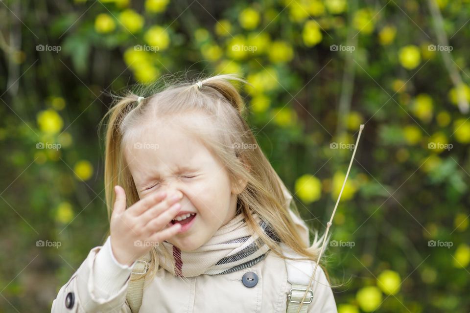 Lifestyle portrait of little Caucasian girl feeling disgust