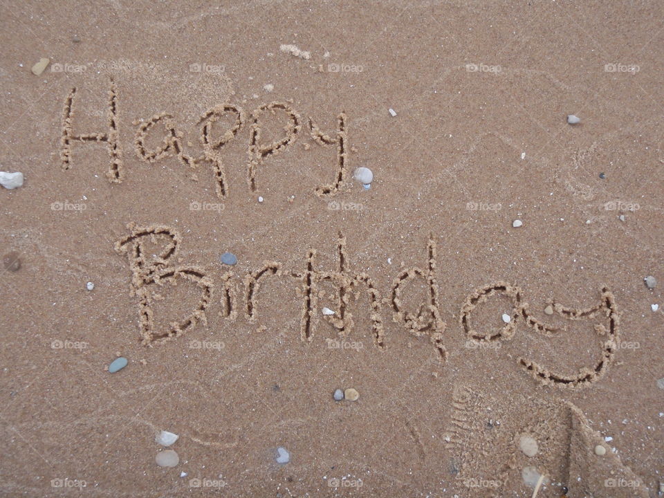 Happy Birthday. Happy Birthday message written in sand