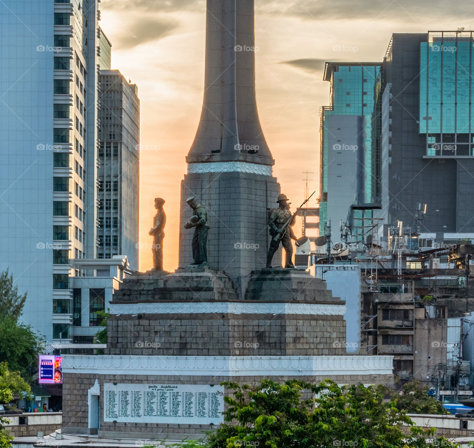 Beautiful sunset scene behind the land mark Victory Monument in Bangkok Thailand