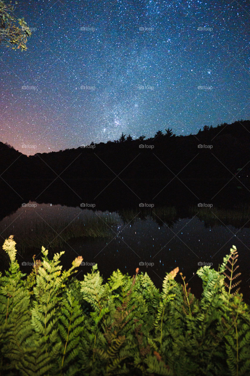 Beautiful views of a starry night seen from a lagoon