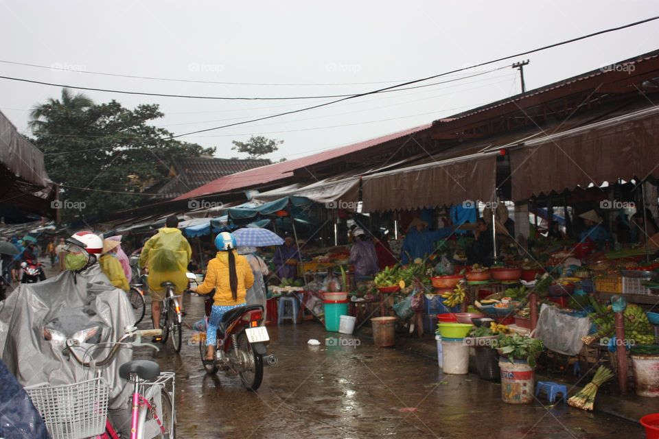 Mopeds and bicycles commuting through the market Vietnam