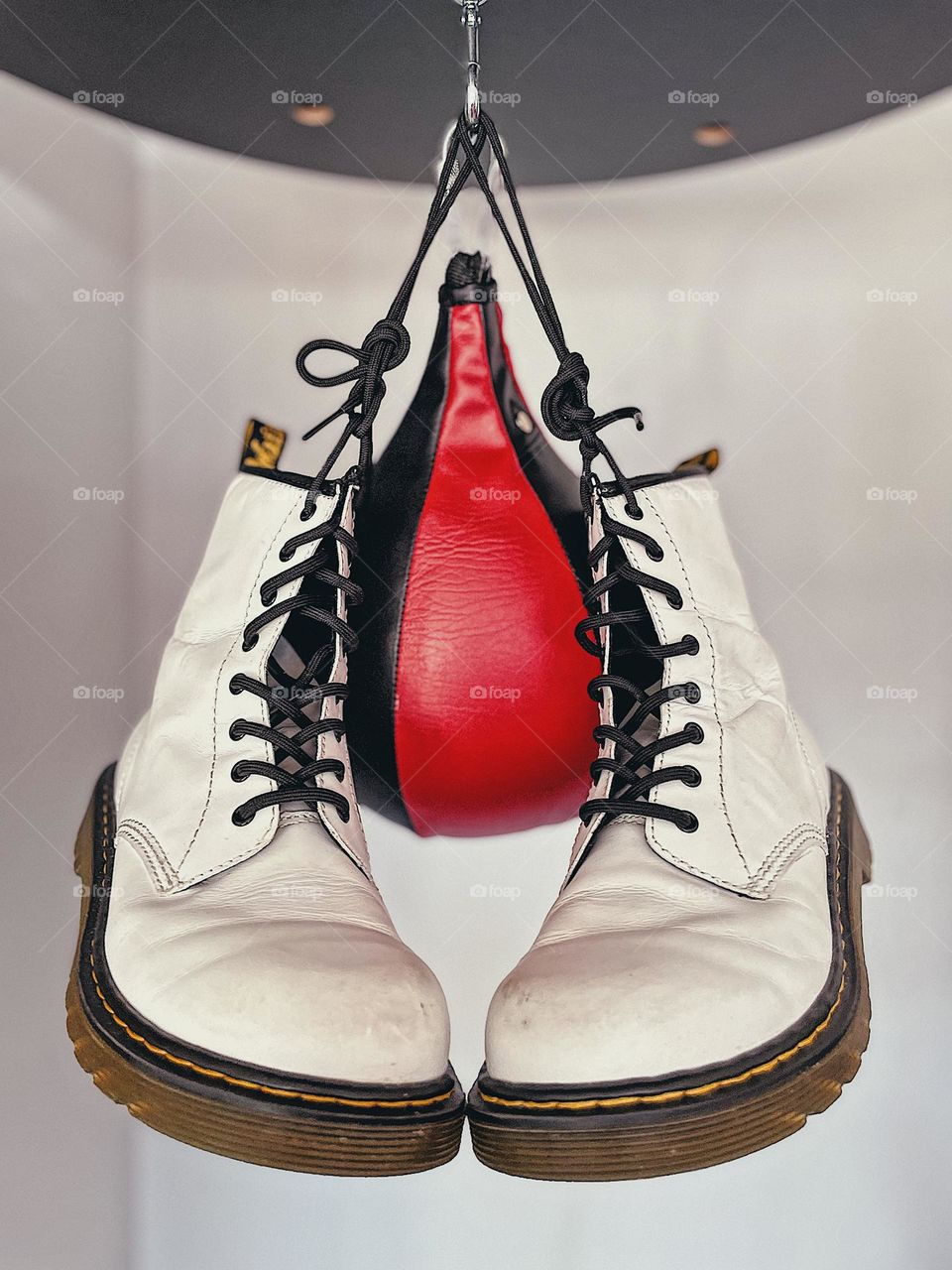 Doc Martens Boots, Dr. martens boots with speed bag, boxing and doc martens, product photography for doc martens boots, sports and boots, white dr. Martens boots, lace up boots with speedbag, boxing photography