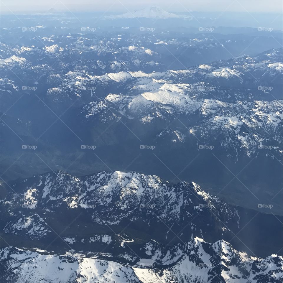 A foggy morning with a layer of mist captured in the mountains from a helicopter this summer.