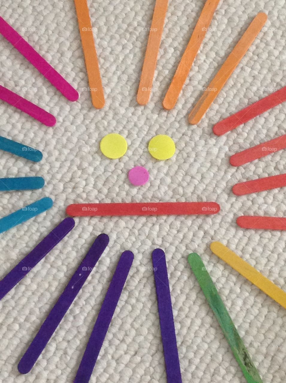 Popcicle sticks and circle stickers for arts and crafts supplies.