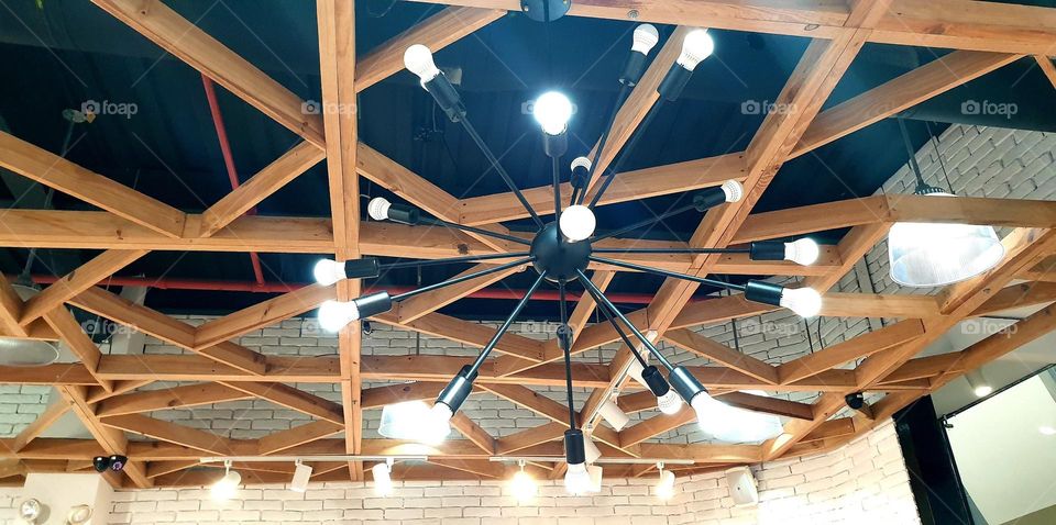 ceiling decorated with wood and metal lamp.  very striking and elegant