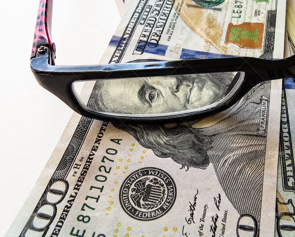 Eyeglasses on dollars banknote