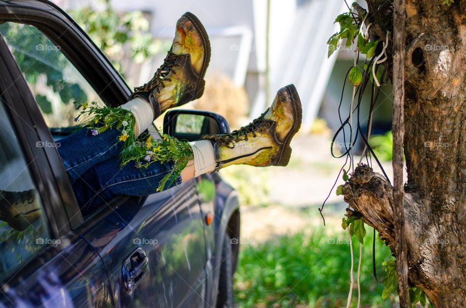 What's that doing here 😃? Woman Lying in Car With her Feet Out of Car Window. She Have Flowers Inside the Boots