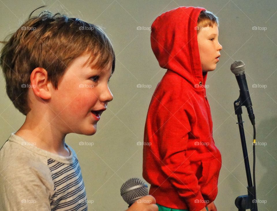 Young Boys Singing In Microphones