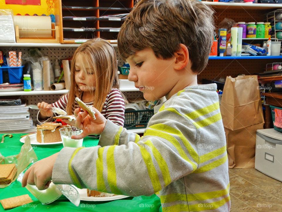 Children Building Christmas Gingerbread Houses
