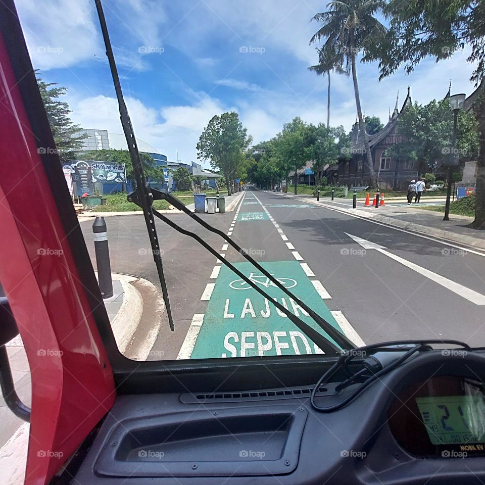 traveling by electric vehicle on empty streets with bicycle lanes on the side