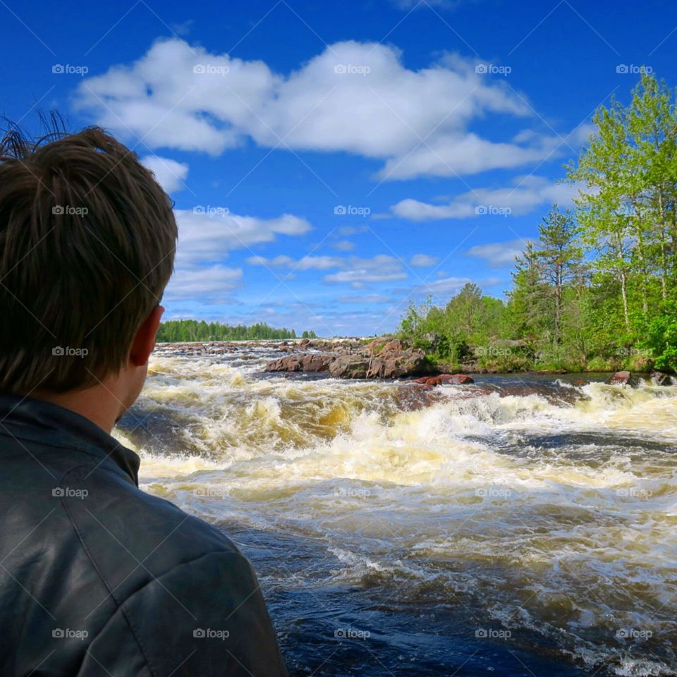 Person  looking  over  waterfall  Sweden  