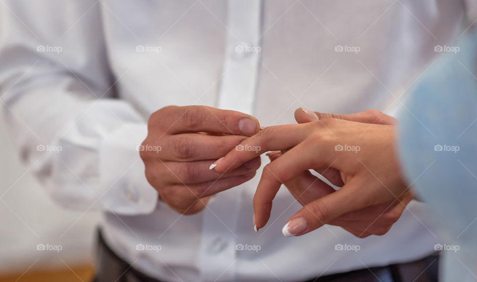 Couple exchanging rings at wedding ceremony