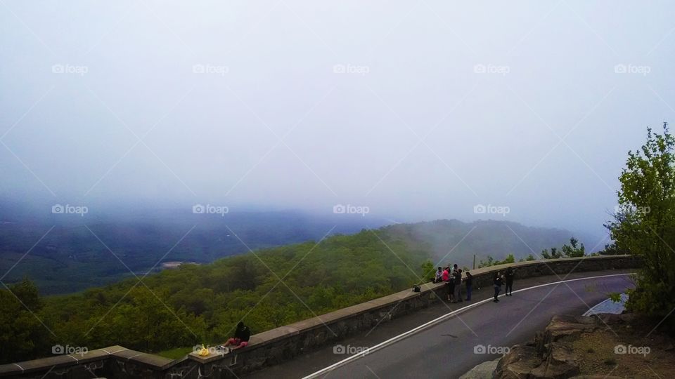Friends sitting on the wall and enjoying the view