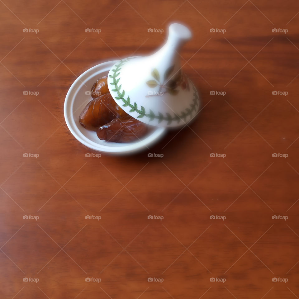 three dates in a white bowl