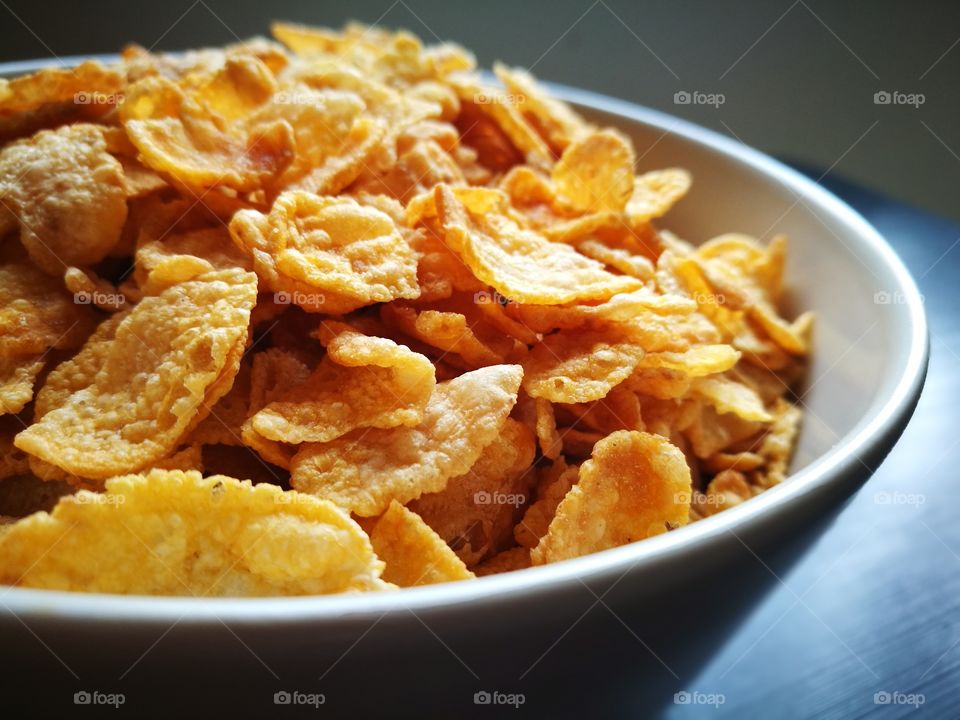 Cornflakes for breakfast on dark background. Cereal. Healthy food.