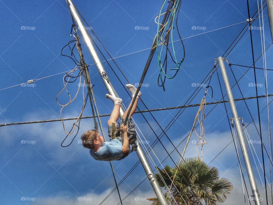 Acrobat Swinging Upside Down