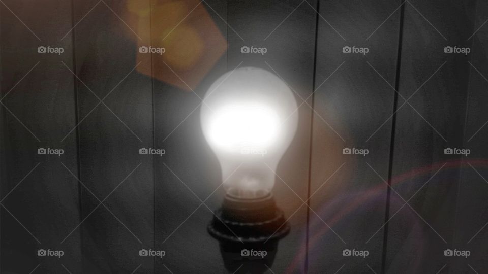Light bulb against wooden background