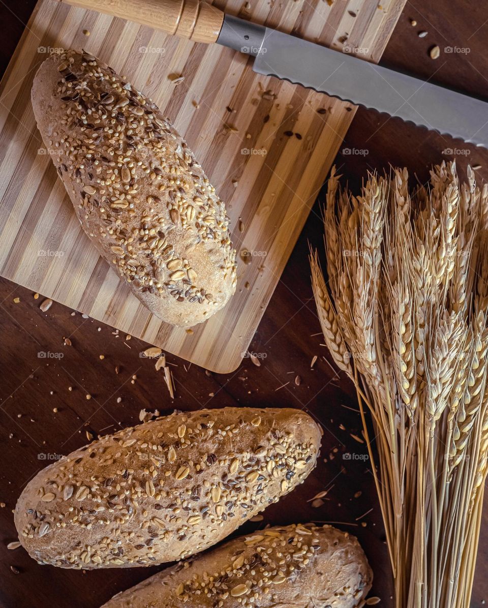 Fresh seeded bread and a sheaf of wheat