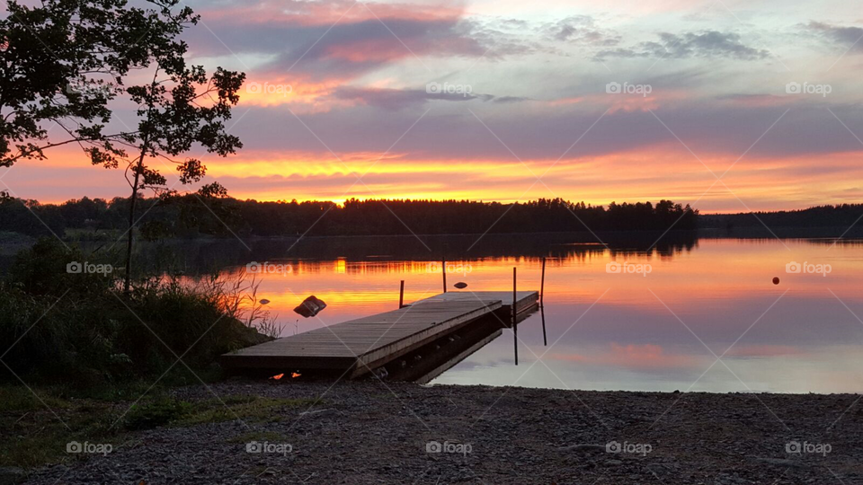 Solnedgång vid bryggan. Från Sörabysjön i Rottne