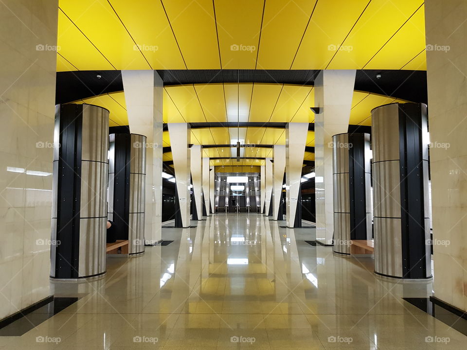 Empty new metro station with yellow ceiling in Moscow