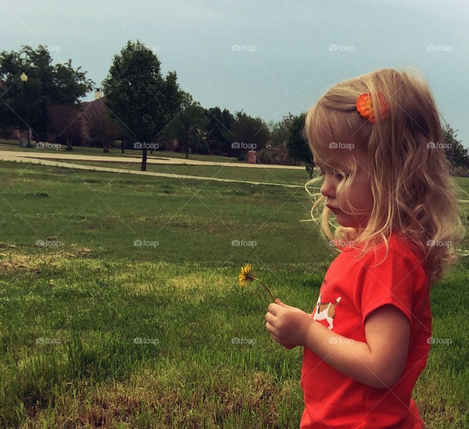 Girl outside. Outside playing with flower