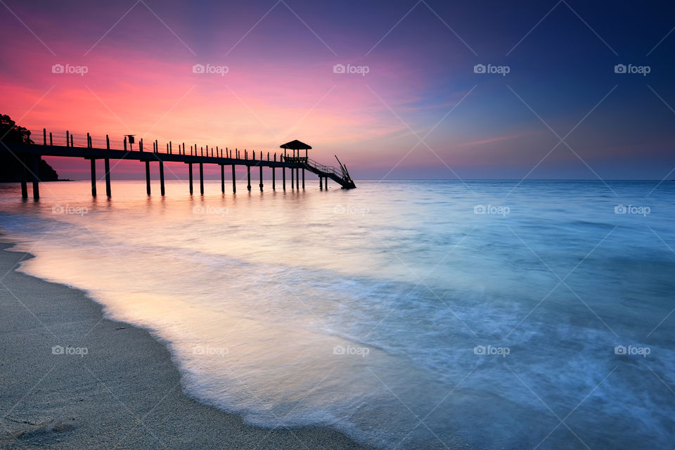 Beautiful sunset over the Kerachut Beach jetty in Penang, Malaysia