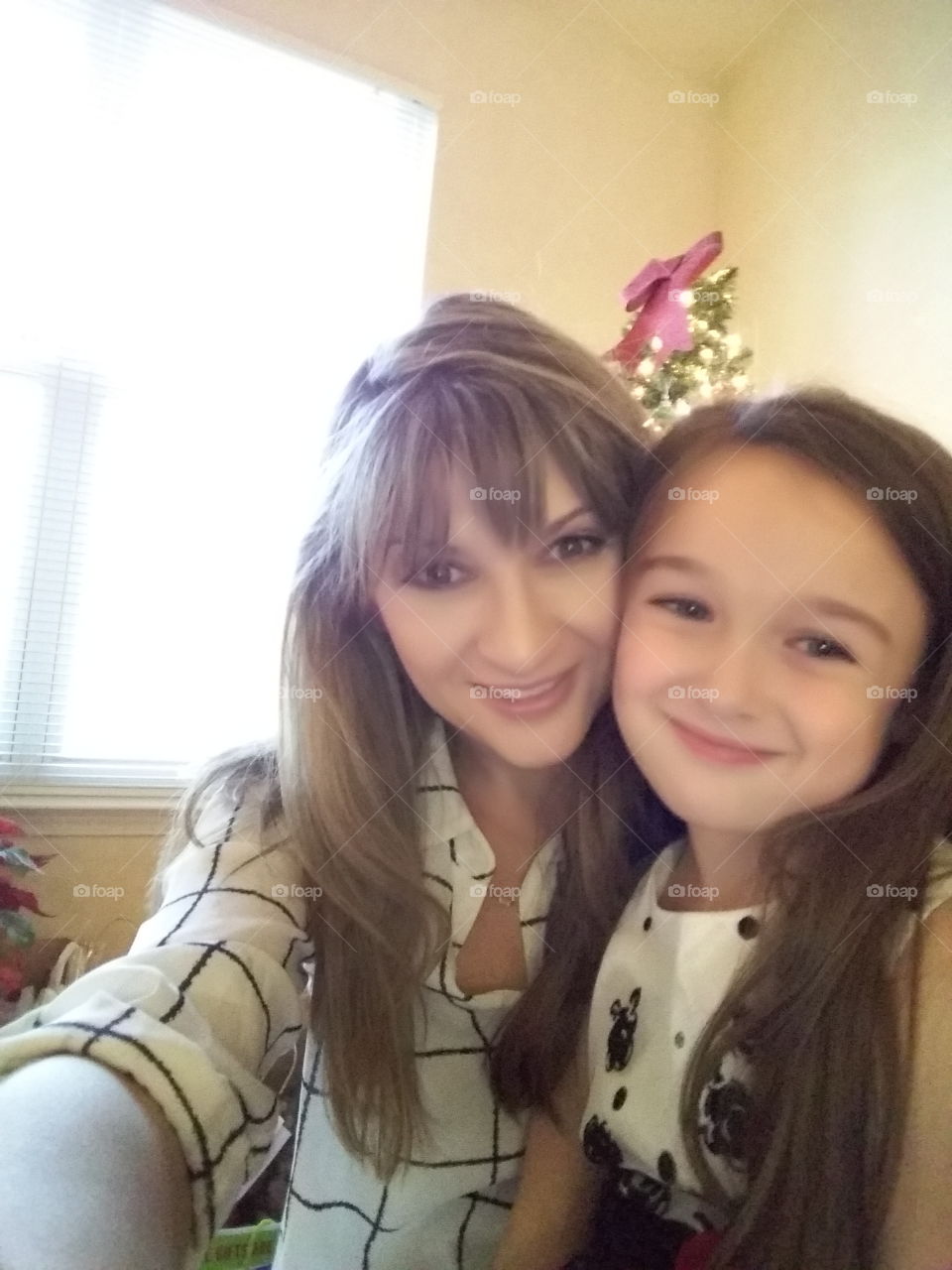 Mother taking selfie with daughter