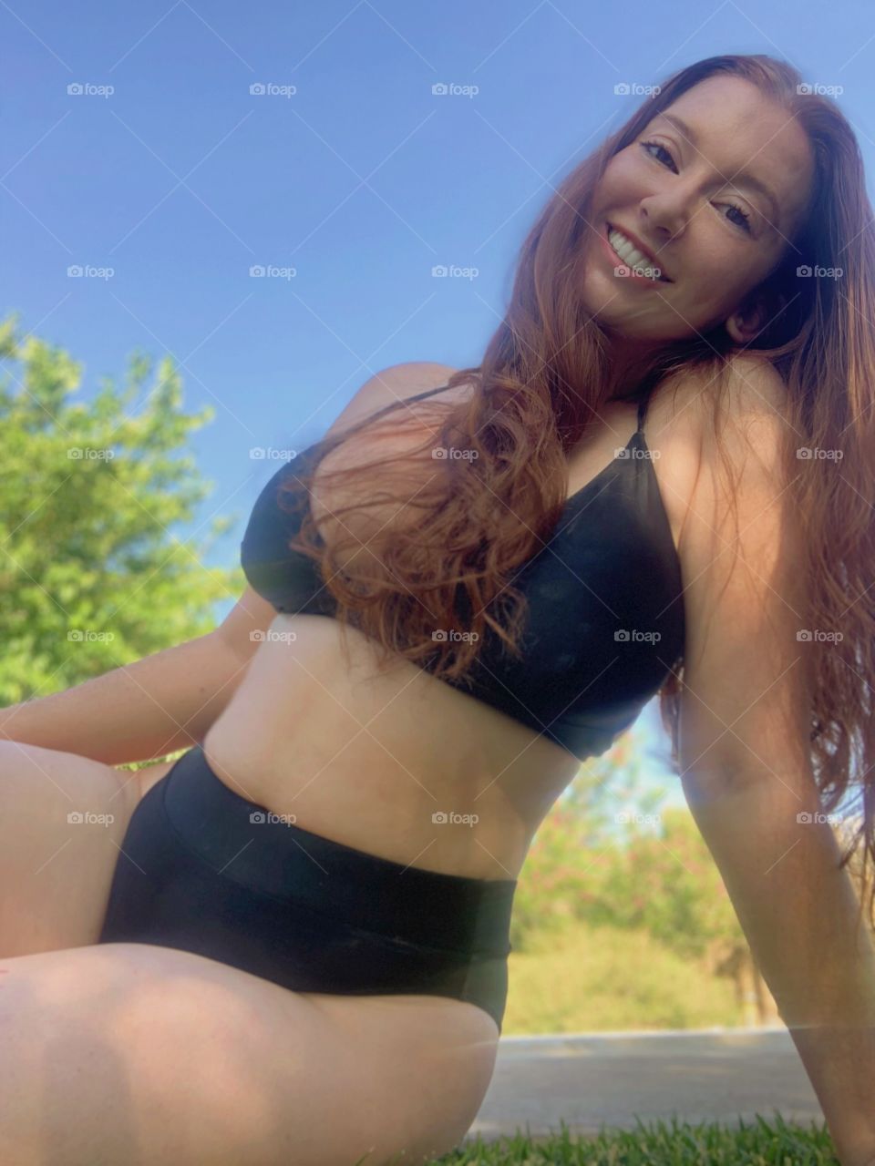 Cute photograph of a young redheaded model posing in a bikini