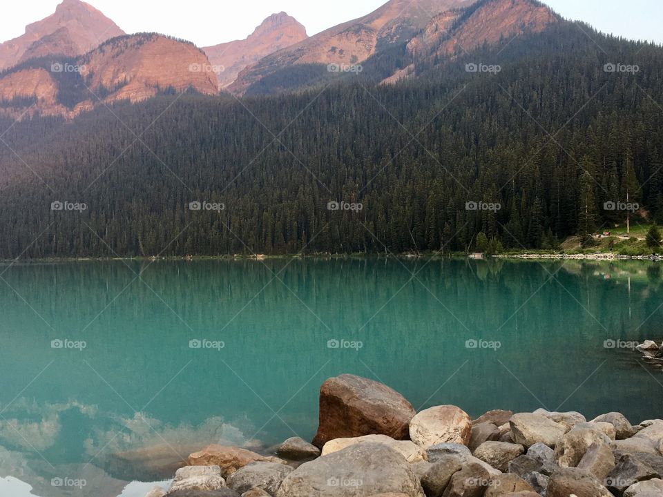 Emerald water at lake Louise in Banff National Park, tree reflections 