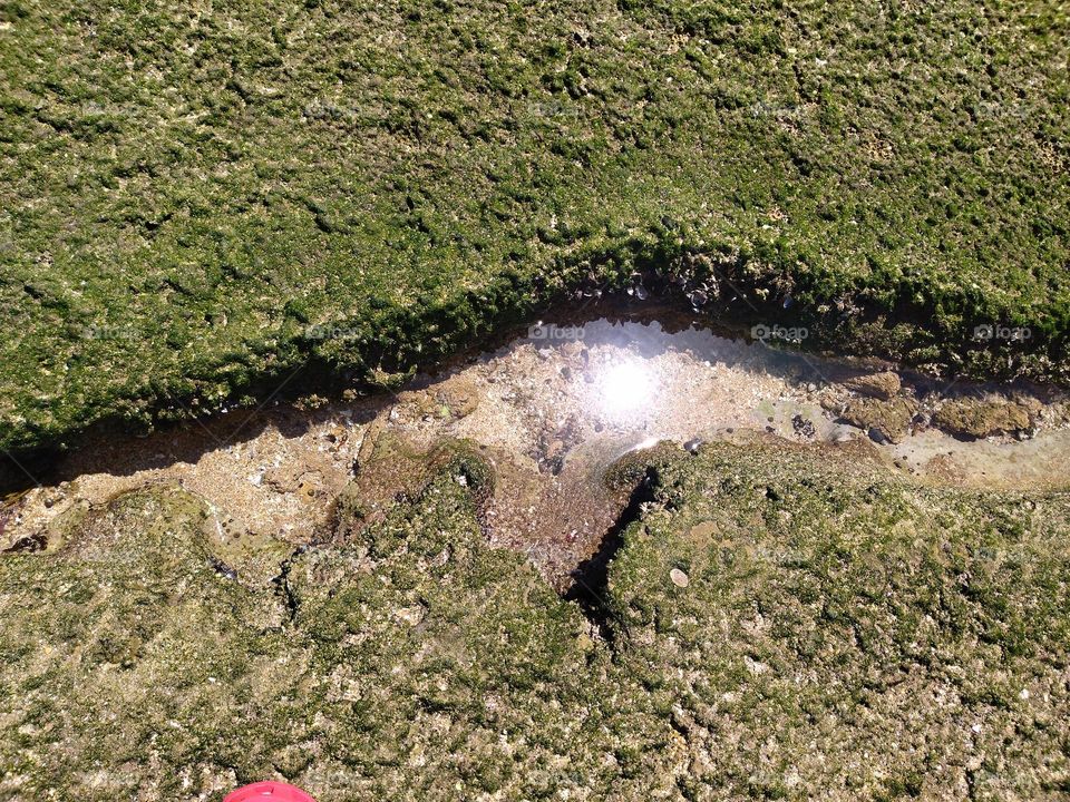 Sunlight between rocks in the water