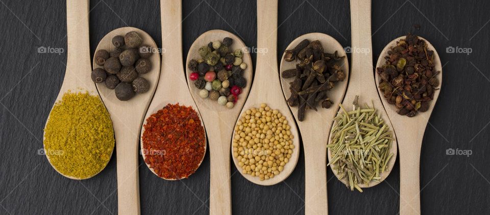 wooden spoons filled with spices