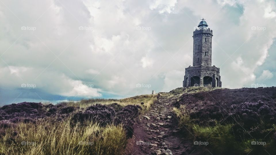 Cloudy sky over Darwen tower on hill