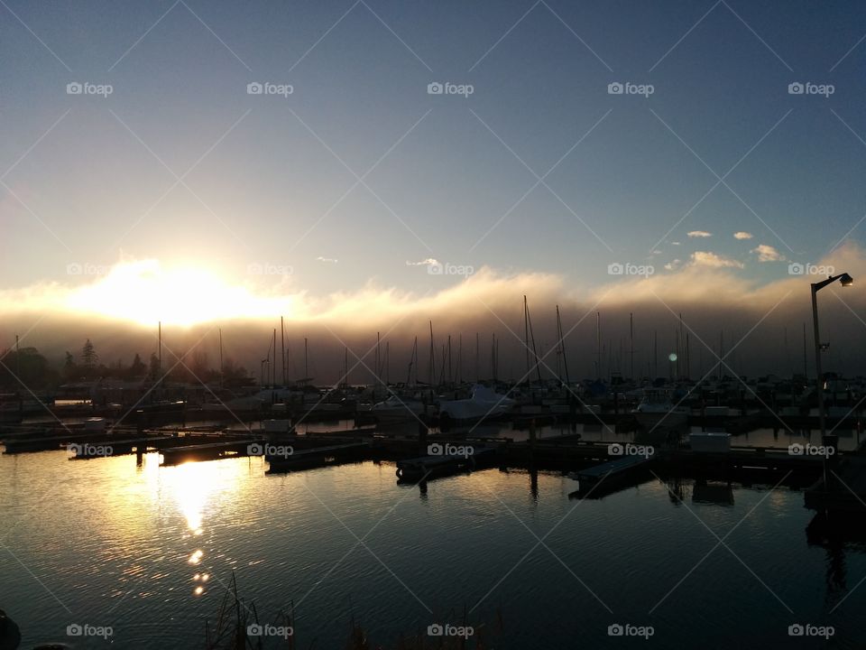Low clouds over harbour sunset.