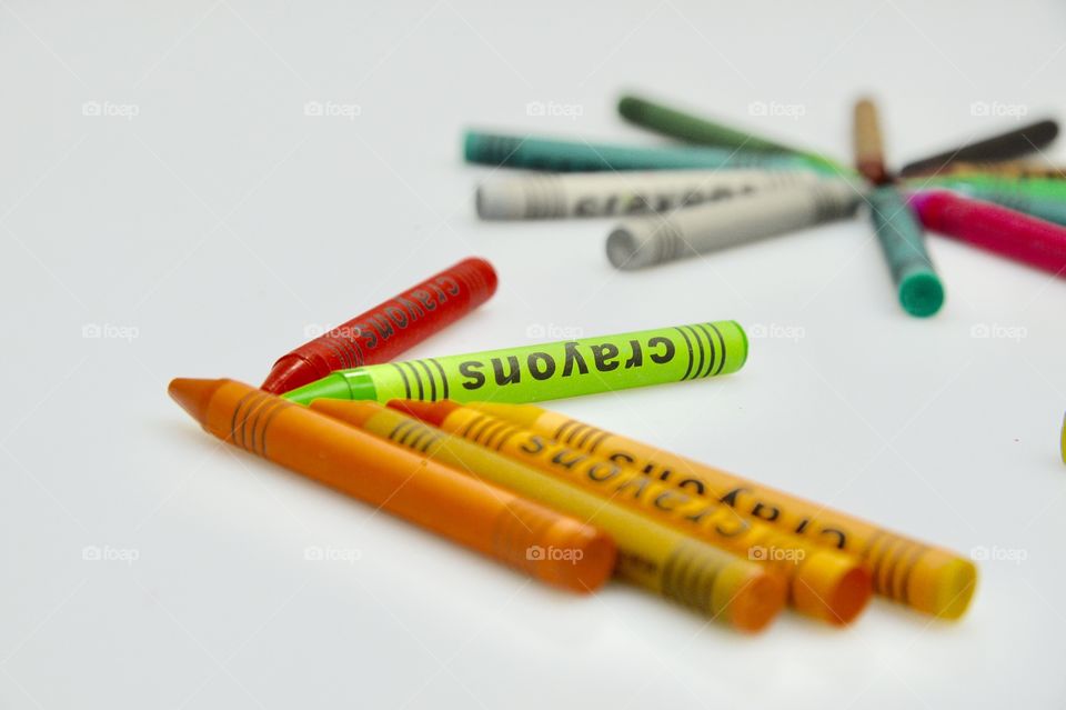the crayons over the white background 