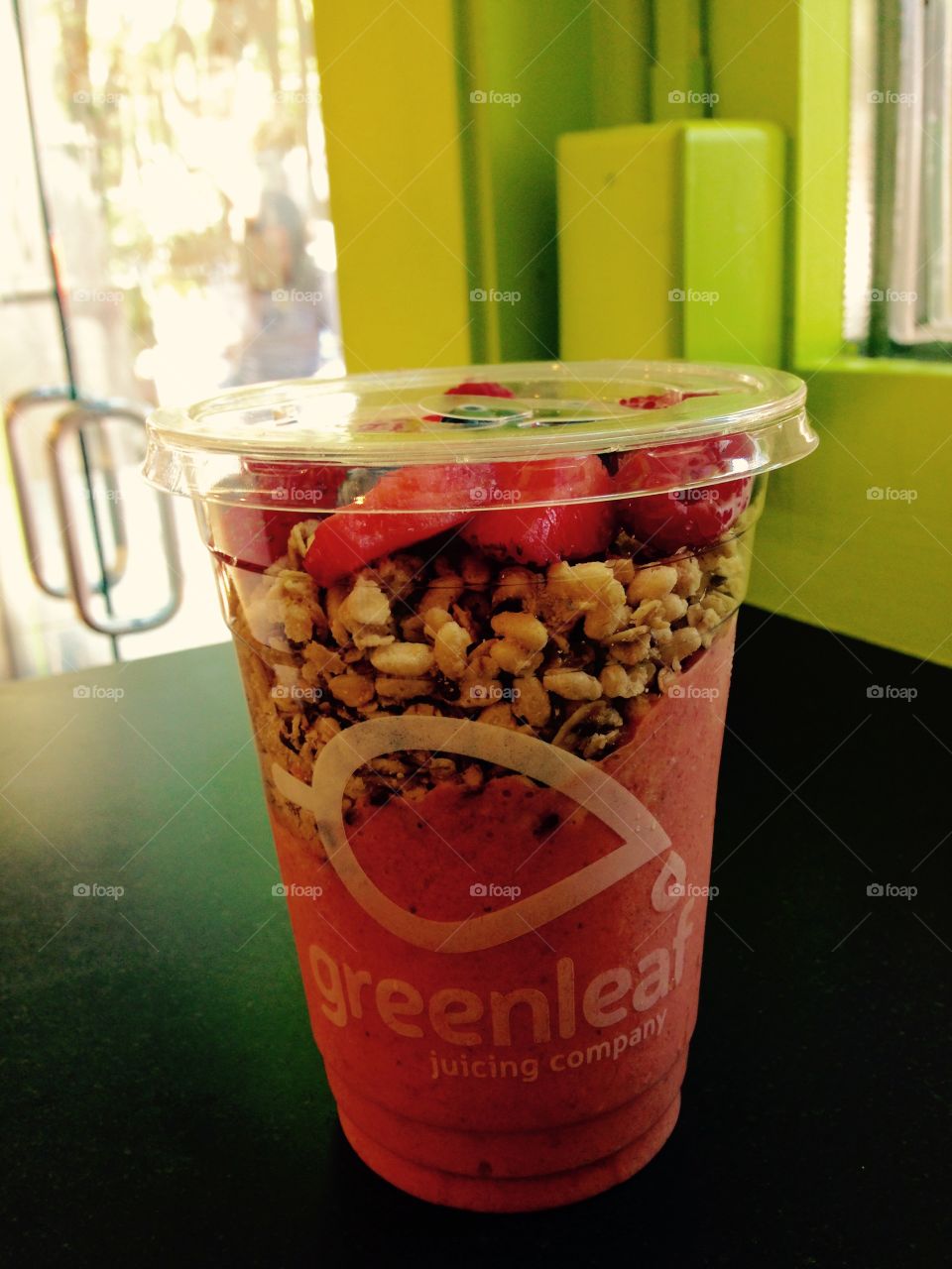 Lunch. Granola smoothie cup from green leaf juice 