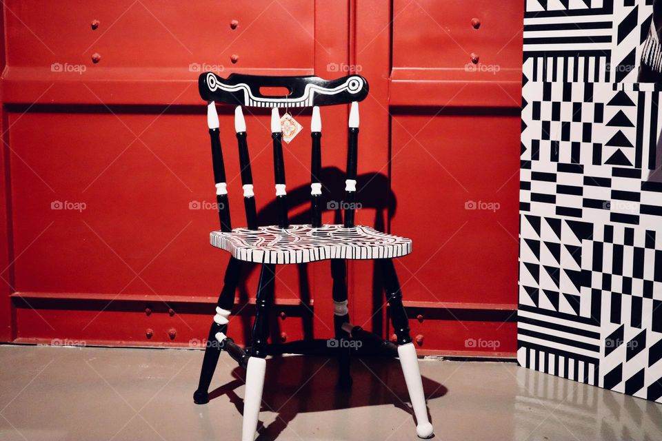 Black and white chair on red background 