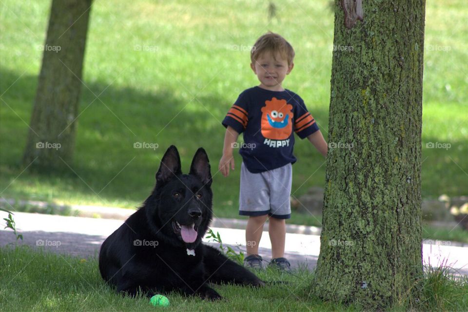 Smiling boy with black dog