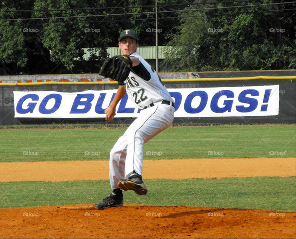 baseball pitcher. young pitcher in full wind-up at national tournament