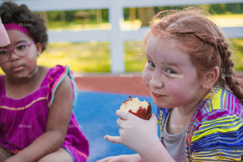 Young Girl Eating an Apple at the Park 2