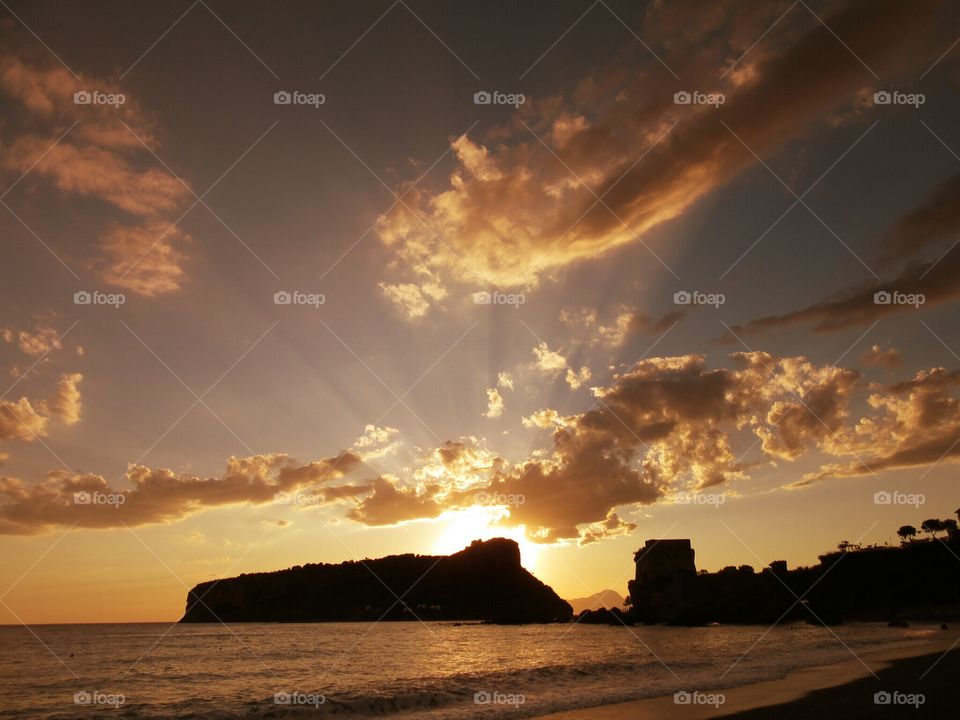 Sunset over Dino Islet at Praia ( Italy ).