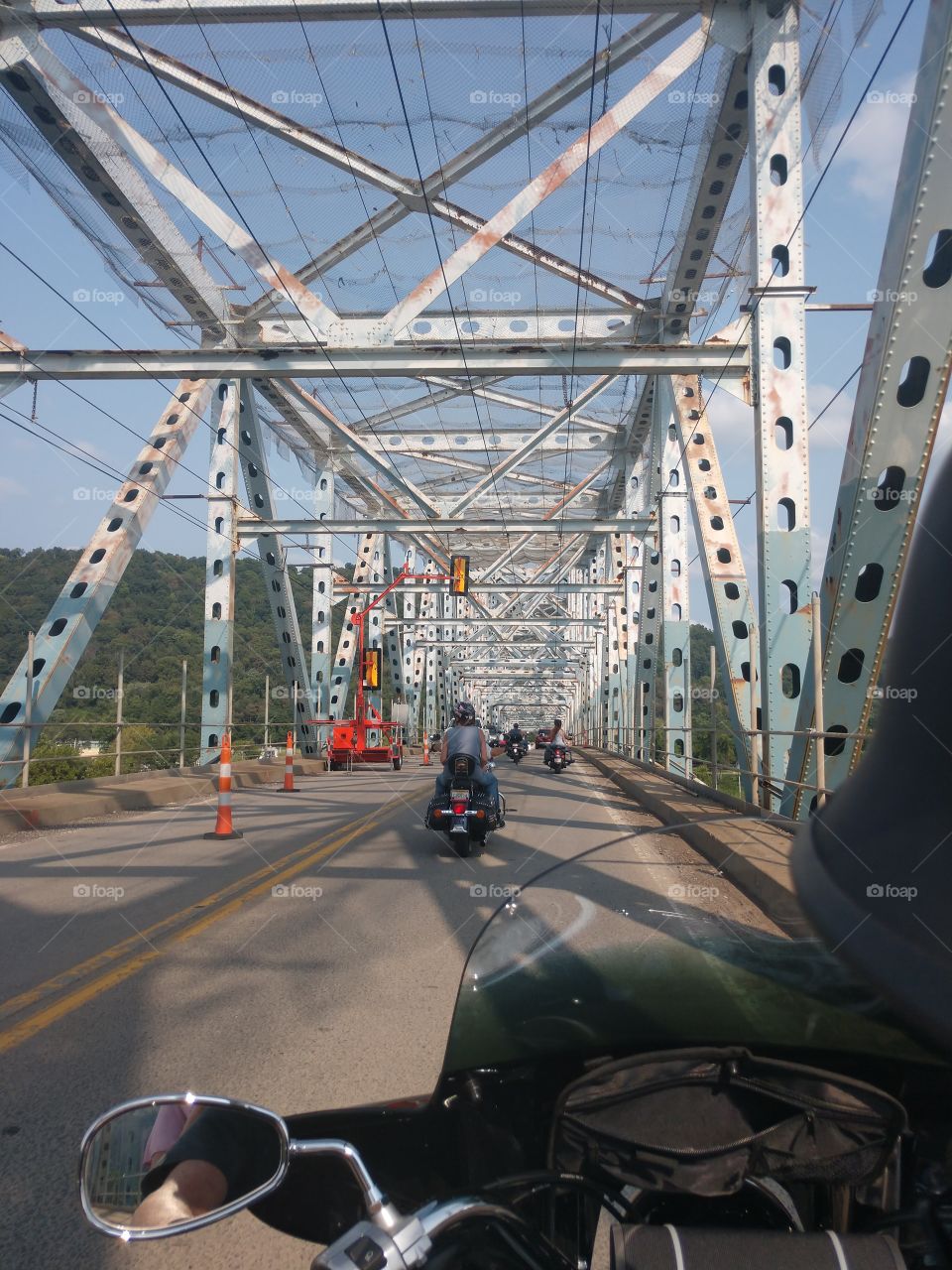 traveling across the state lines, over the river, via a bridge on a motorcycle.